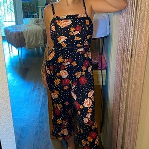 black jumpsuit, orange & red floral pattern